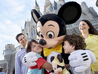 Mickey Mouse hugging children at Walt Disney World